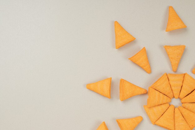 Triangle shaped chips on gray surface