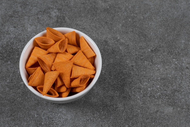 Triangle shaped chips in white bowl.