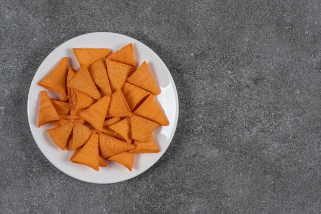 Triangle shaped chips on white plate.
