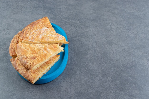 Triangle shaped pastries on blue plate.