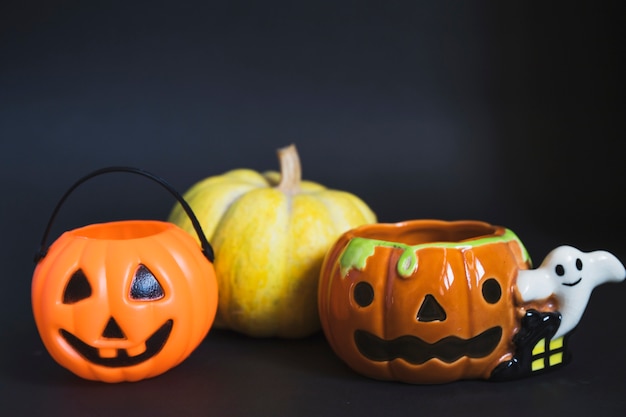 Trick or treat basket near pumpkin and candleholder