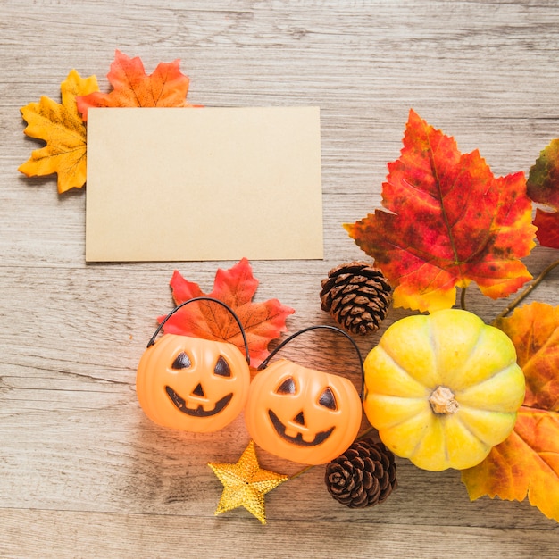 Trick or treat baskets and autumn symbols near paper