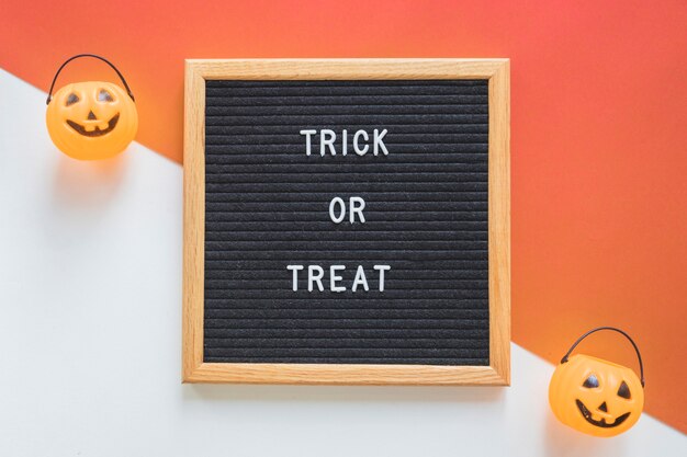 Trick or treat baskets near frame with writing