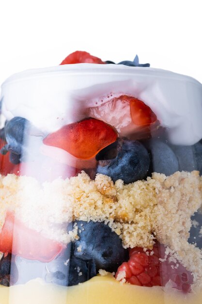 Trifle dessert with berries and cream isolated on white background