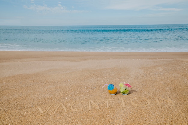 Tropical beach with cocktails and inscription