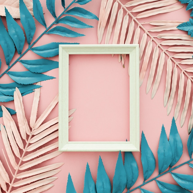 Free photo tropical blue and pink palm leaves with white frame on pink background