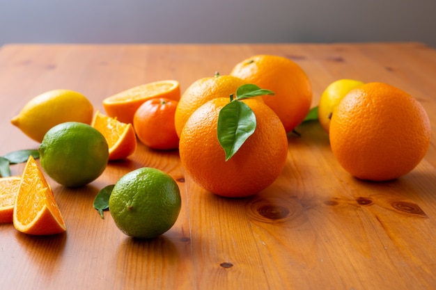 Tropical citrus fruits standing on wooden desk