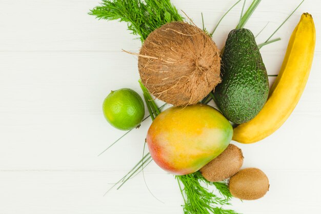 Tropical fruits and green herbs