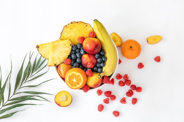 Tropical fruits on a white background top view