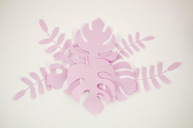 Free photo tropical leaves in paper cut style