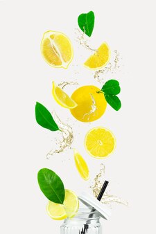 ストロー​、​柑橘類​、​ビタミン​c​の​ボトル​に​落ちる​熱帯​の​有機​レモン​フルーツ​。​レモン​スライス​。​レモン​、​スプラッシュ​、​葉​で​作られた​クリエイティブ​な​レイアウト​。