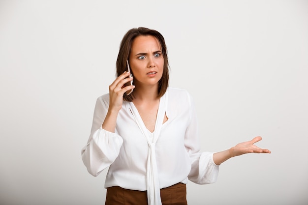 Troubled fashion woman talk phone, look concerned