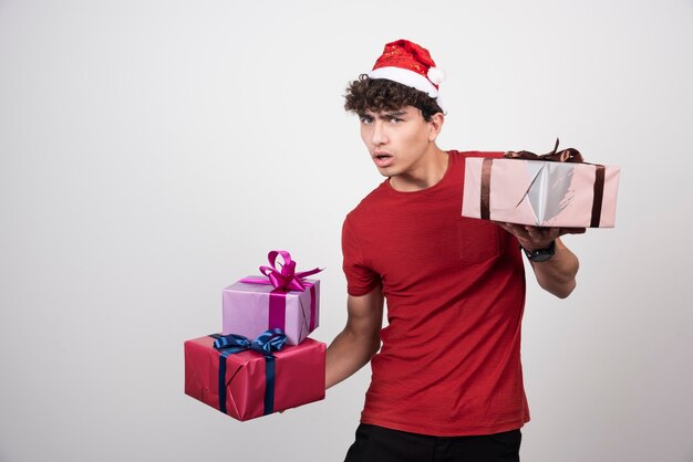 Troubled man holding his Christmas gifts.