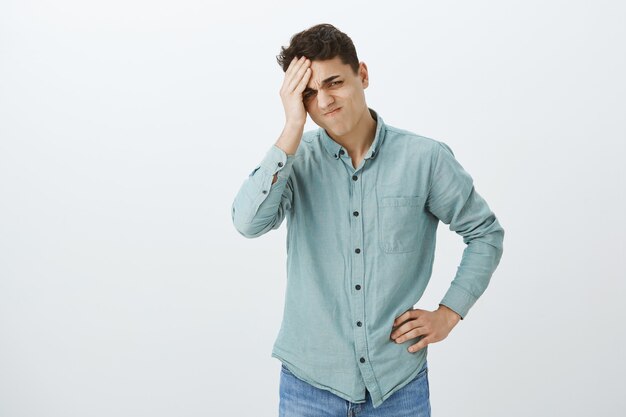 Troubled upset young man in casual shirt