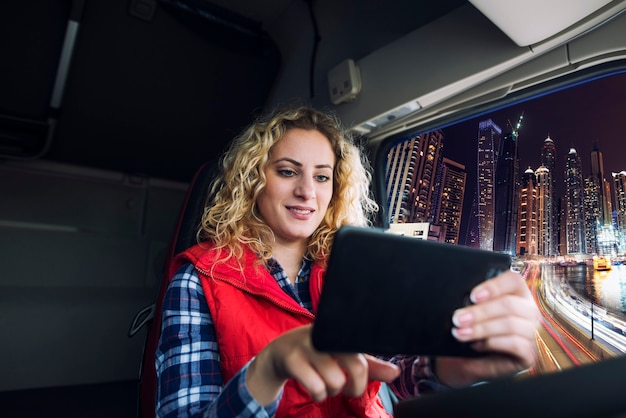 Free photo truck driver using gps navigation device to navigate through large city traffic to get to the destination