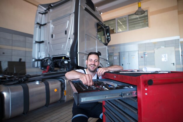 Truck mechanic and serviceman choosing tools for vehicle maintenance