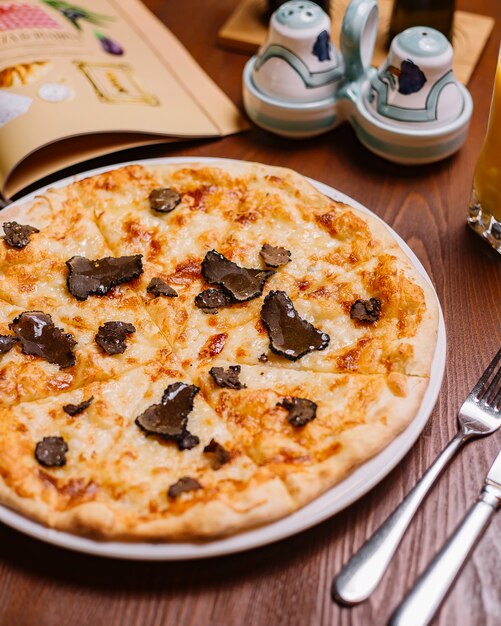 Truffle pizza garnished with olive oil