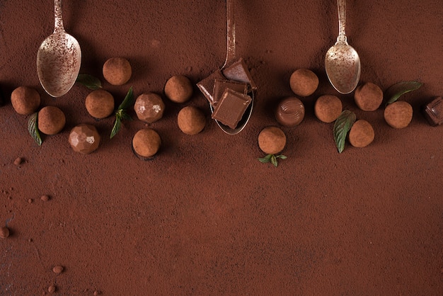 Truffles with chocolate bar squares and spoons anc copy space