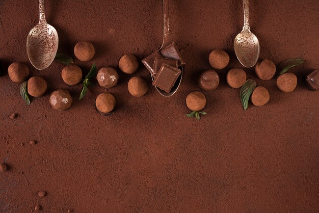 Truffles with chocolate bar squares and spoons anc copy space