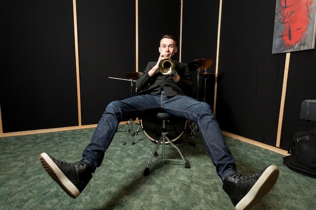 Trumpet player chilling on chair