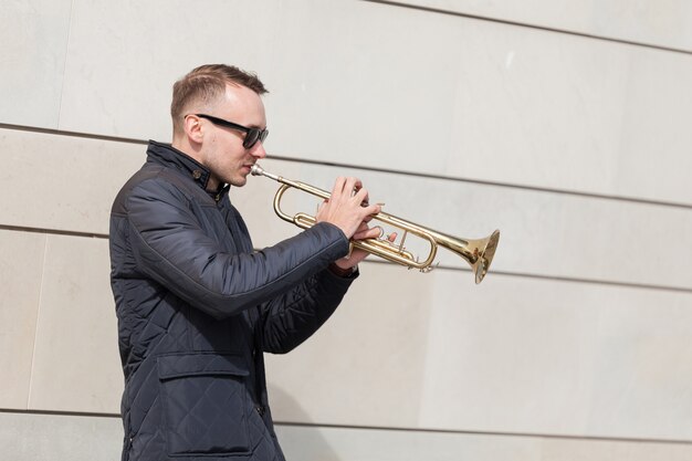 Trumpet player playing outdoors