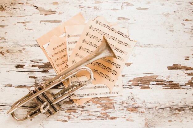 Trumpet and sheet music on crumblin tabletop