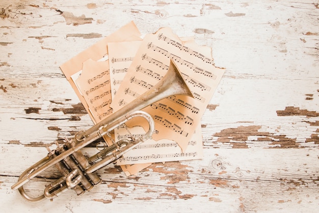 Trumpet and sheet music on crumblin tabletop