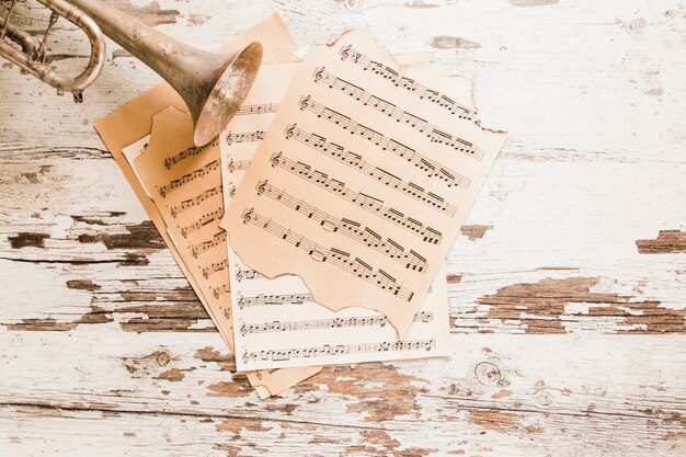 Trumpet and sheet music on old table