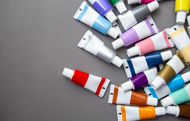 Free photo tubes of acrylic paint in different colors flat lay