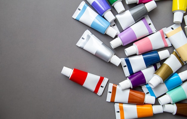 Tubes of acrylic paint in different colors flat lay