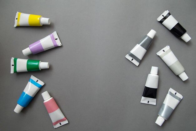 Tubes of acrylic paint in different colors flat lay