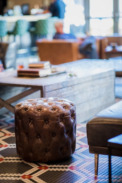 Tufted brown leather ottoman