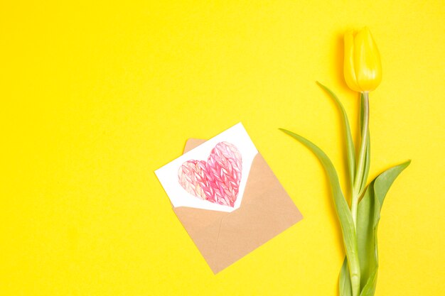 Tulip flower with heart drawing in envelope