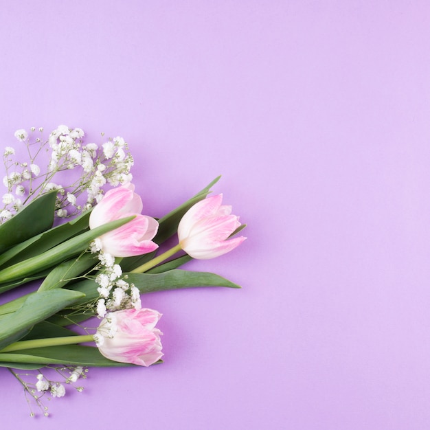 Tulip flowers bouquet with branches on table