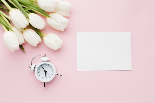 Tulip flowers with clock and empty paper