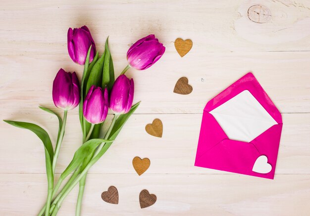 Tulip flowers with envelope and small hearts 