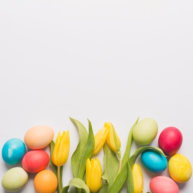 Tulips among colored eggs