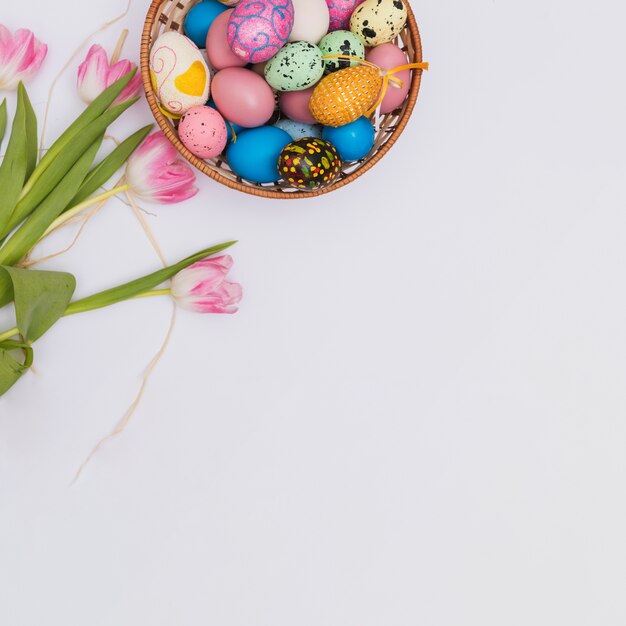 Tulips near bowl with eggs