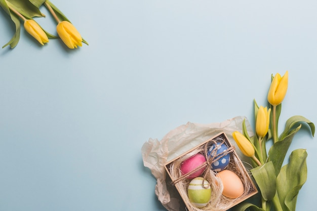 Tulips near box with eggs