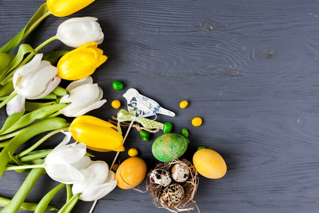 Tulips near eggs and bird