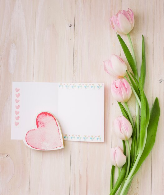 Tulips with blank paper and heart