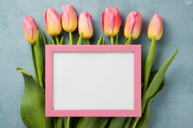 Tulips with frame on table