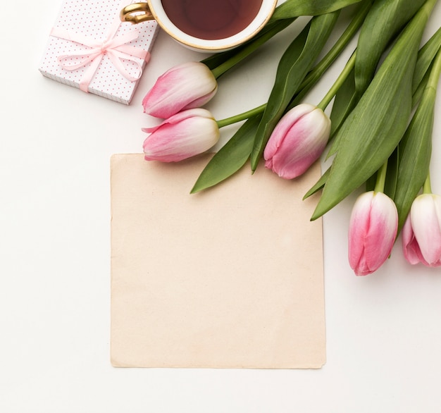 Free photo tulips with gift and greeting card