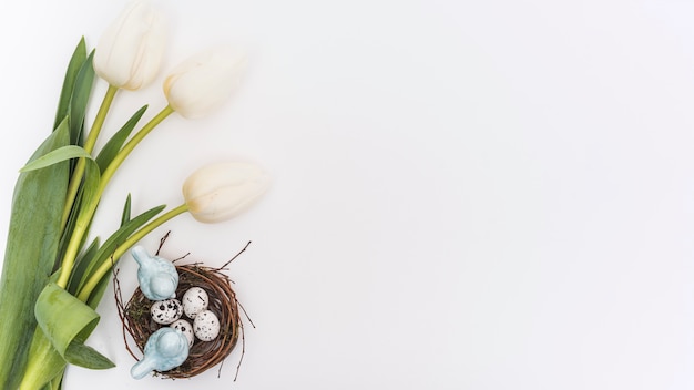 Free photo tulips with quail eggs in nest