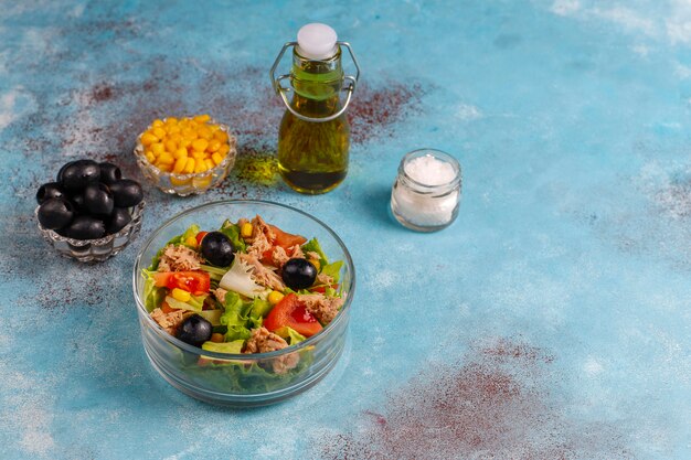 Tuna salad with lettuce,olives,corn,tomatoes,top view