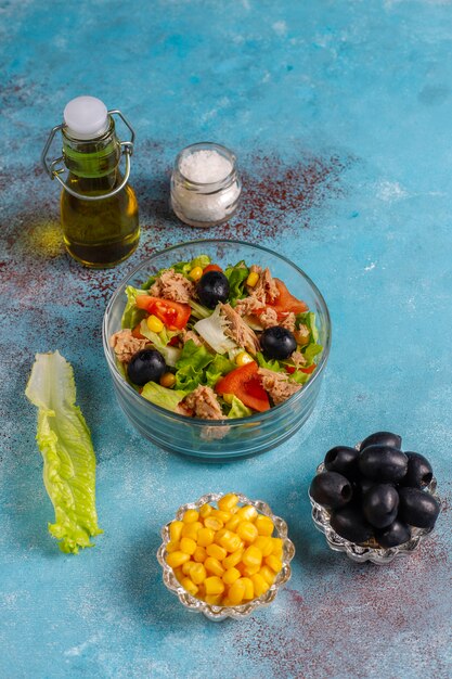 Tuna salad with lettuce,olives,corn,tomatoes,top view