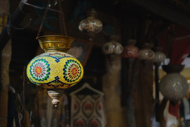 Turkey a market with traditional colorful handmade Turkish lamps and lanterns selective focus on a lantern blurred background lanterns hanging in a store for sale Popular souvenirs