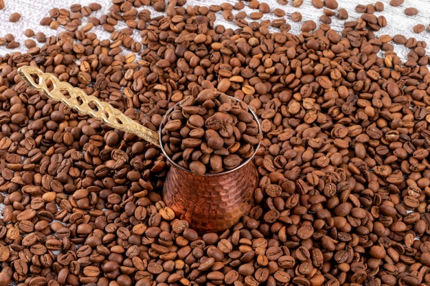 Turkish coffee pot on coffee beans