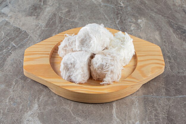 Turkish cotton candy in a wooden plate on blue.