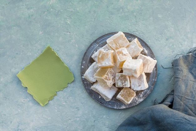 Turkish delight on plate with small paper and cloth 